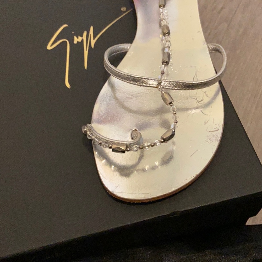 Giuseppe Zanotti Flat toe loop sandals with magnetic crystal tie ups.